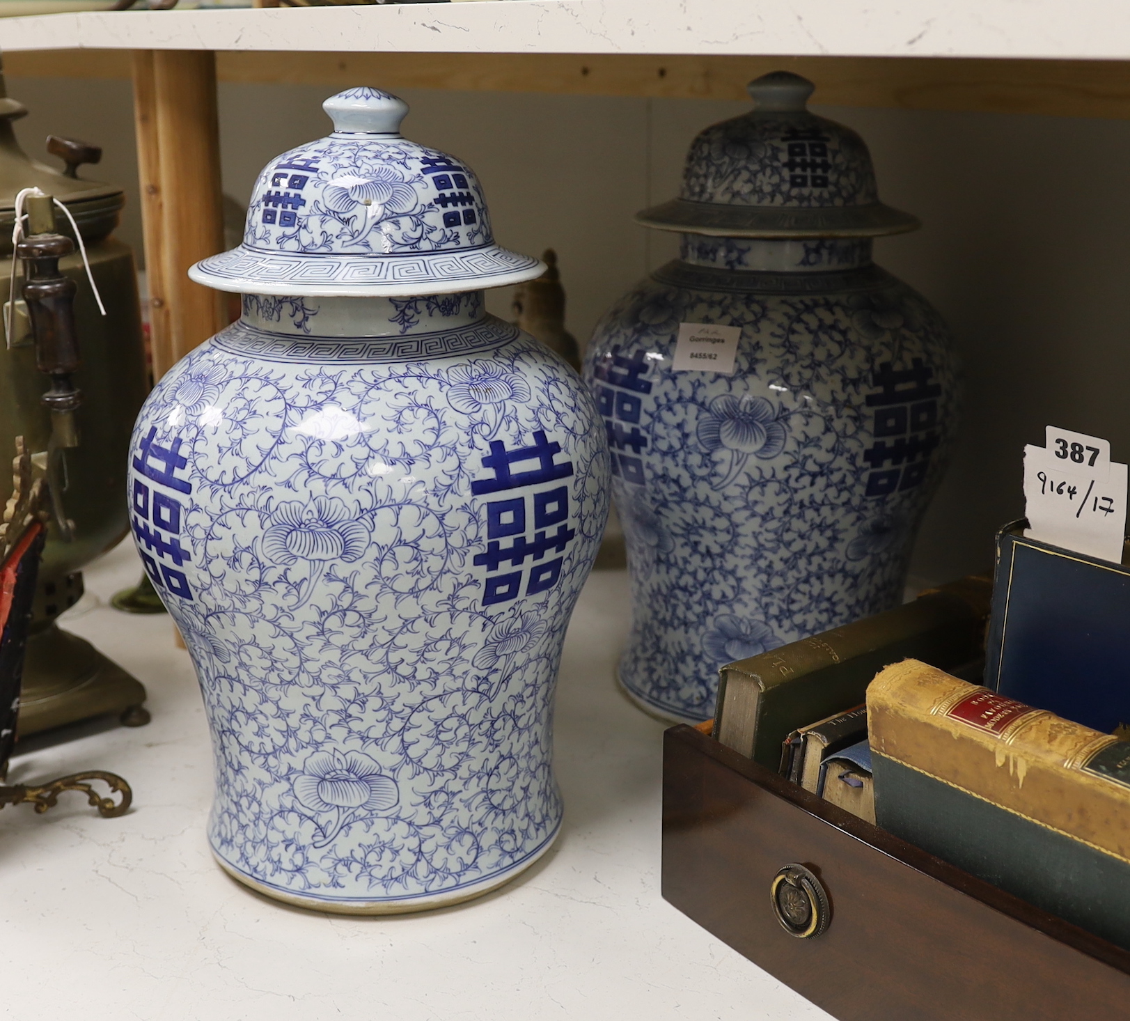 A pair of 19th/20th century Chinese blue and white ‘shuangxi’ baluster lidded vases, 43cm